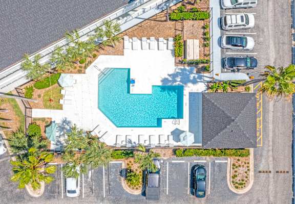 an overhead view of a pool in a parking lot with cars at The Teale, Kissimmee, FL, 34746