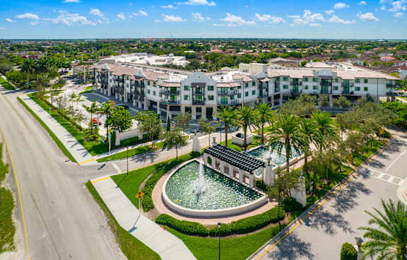 an aerial view of the resort properties with a fountain in the middle of a grassy area