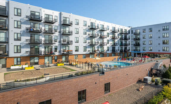 an aerial view of an apartment building with a swimming pool