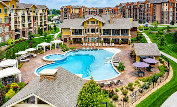 A large house with a pool in the middle of it.