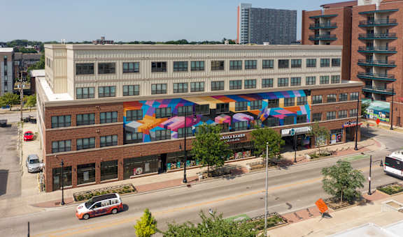 a building with colorful umbrellas on the side of it