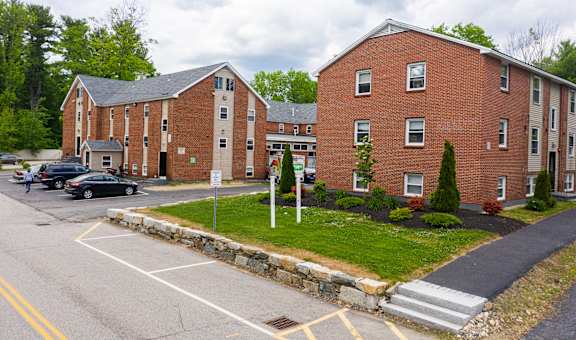 a large brick building with cars parked in front of it