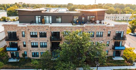 an aerial view of a brick building with a roof top terrace
