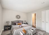 Thumbnail 7 of 8 - A bedroom with a large bed and a grey headboard.