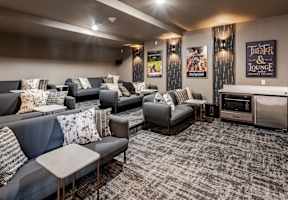 a living room with couches and chairs and a tv