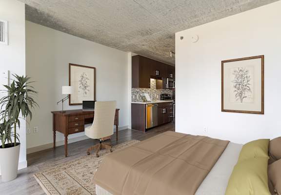 A room with a couch, desk, and chair.