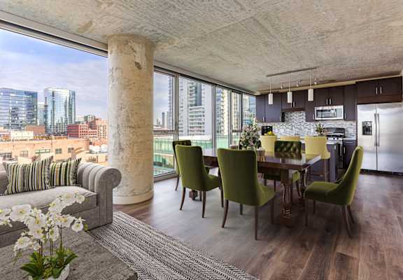 A modern kitchen with a dining table and chairs.