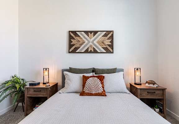 a bedroom with a bed and two night stands with lamps