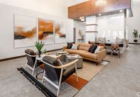 a living room with a couch and chairs and a table