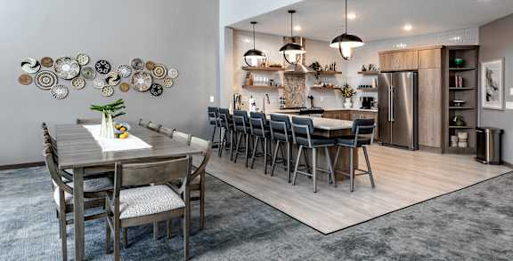A modern kitchen with a dining table and chairs.