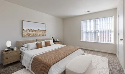 A bedroom with a large bed and a painting on the wall.