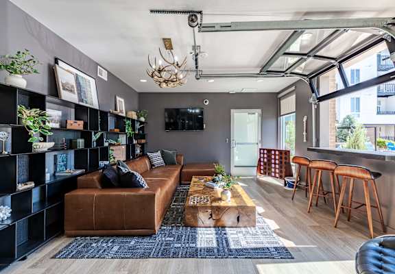 a living room with a brown leather couch and a coffee table