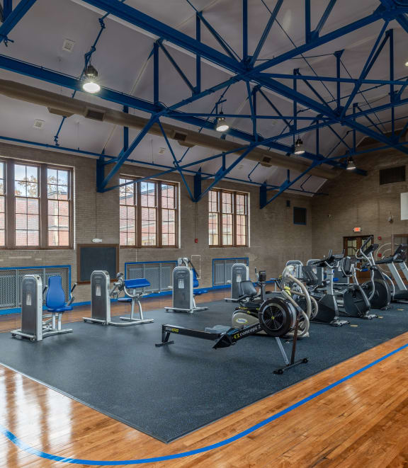 a home gym with a yellow exercise bike and yellow weights