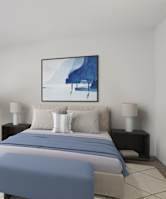 A bedroom with a large bed and a painting on the wall.