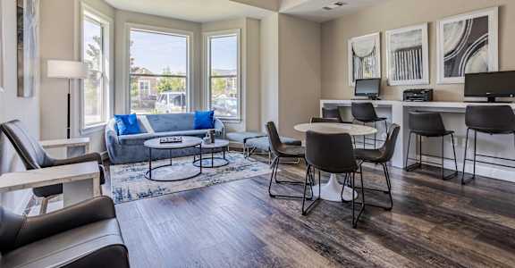 a living room with a couch and a table and chairs