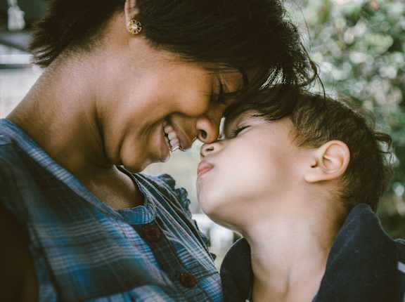 a woman and a child looking at each other