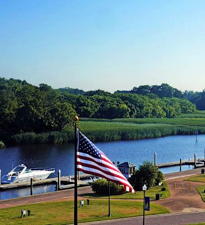 a view of a river with boats and an flag