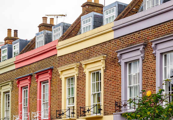 A row of houses with different colored facades.