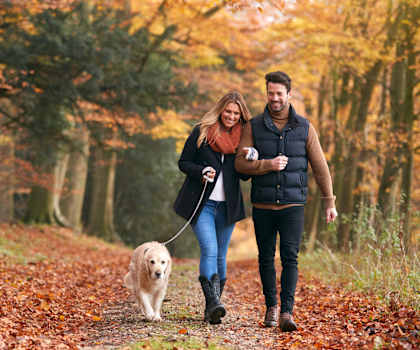 a man and woman walking their dog in the woods at Pleasant View Estates, Griswold, Connecticut