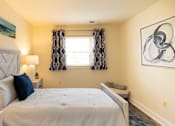 Thumbnail 9 of 12 - Bedroom with a large bed and a window at Rockdale Gardens Apartments*, Baltimore.