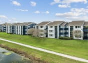 Thumbnail 13 of 13 - an image of an apartment building next to a body of water