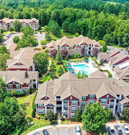 an aerial view of a neighborhood with houses and a swimming pool