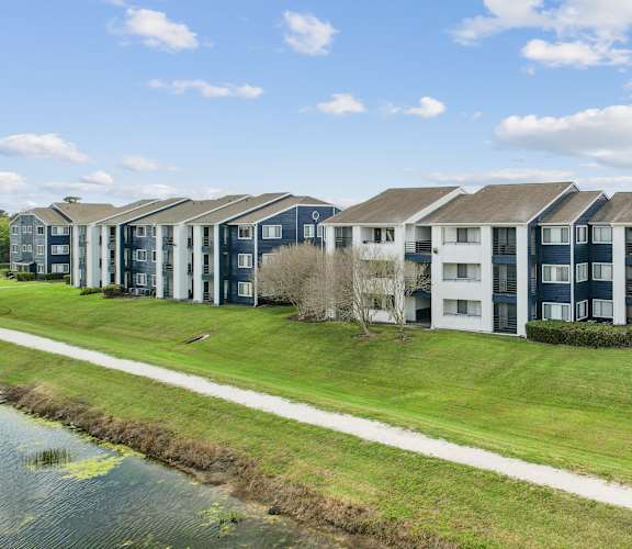 an image of an apartment building next to a body of water