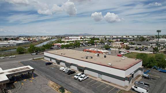 A large building with a parking lot in front of it.