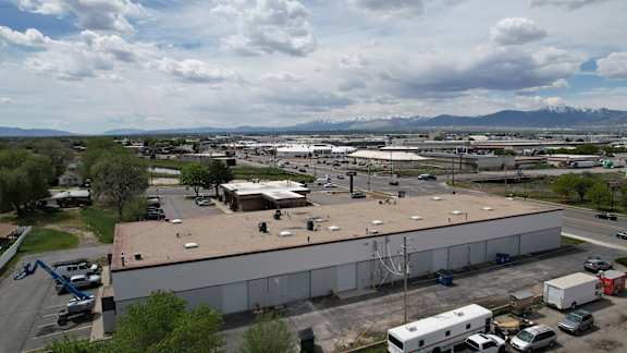 A large building with a parking lot in front of it.