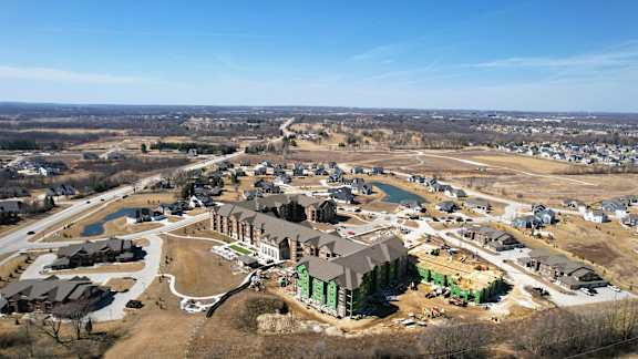A bird's eye view of a residential area with a large house in the center.