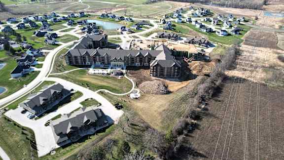 A bird's eye view of a residential area with houses and a large building.