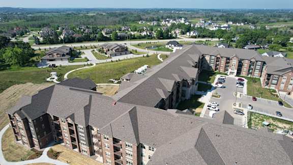 A large building with a parking lot in front of it.