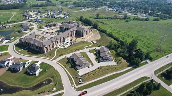 A bird's eye view of a residential area with a large apartment complex in the center.