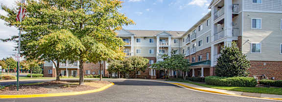 an empty street in front of an apartment building