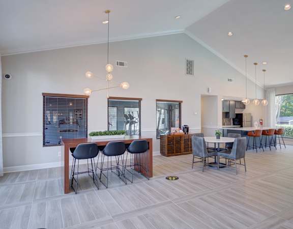 A modern dining room with a long table and chairs.