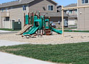 Thumbnail 9 of 9 - A playground with a green slide and a brown wooden structure.