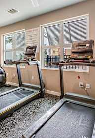 the gym with treadmills and exercise equipment at 1861 muleshoe road apartments