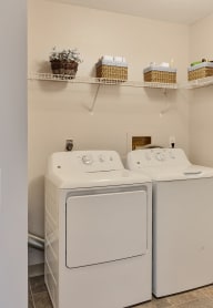 a washer and dryer in a laundry room with a door to the room