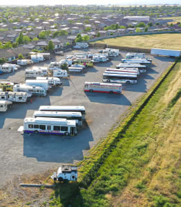 a group of buses parked in a parking lot
