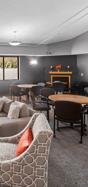 A living room with a grey couch and a wooden table.