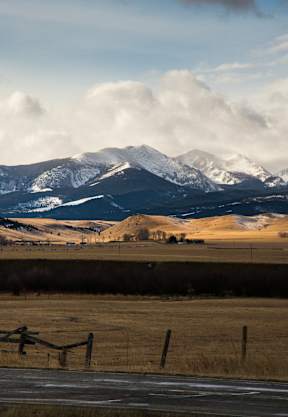 a view of a field with mountains in the background