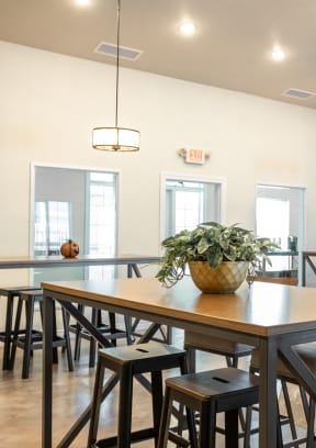 a dining room with a table and chairs and a projection screen