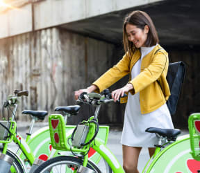 a woman is standing next to a group of bikes