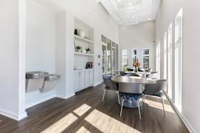 A modern kitchen with a dining table and chairs.
