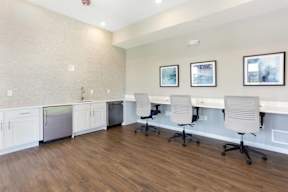 A room with a white counter and chairs.