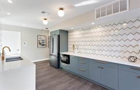 A well-appointed apartment kitchen with stainless steel appliances and ample counter space.