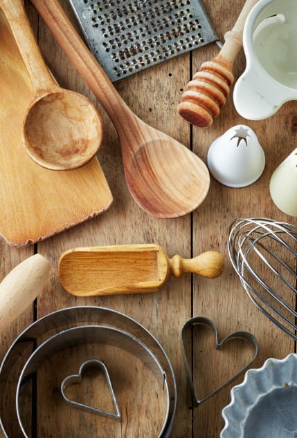a selection of kitchen utensils and tools on a wooden table