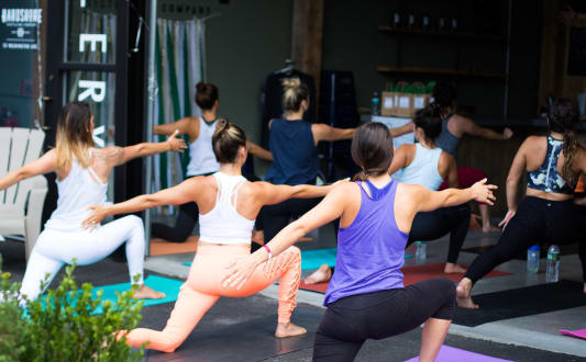 a group of women doing yoga in a yoga class