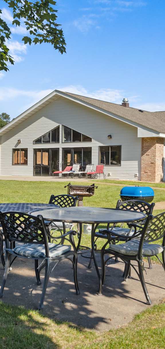 A house with a patio and a table set for four.