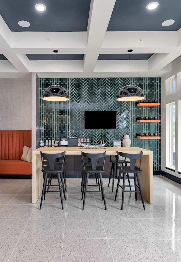 a kitchen with a sink and a tv on the wall